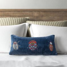 a bed with two bugs embroidered on it