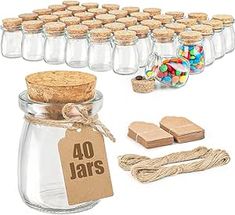 glass jars with corks and wooden tags are shown in front of the jar, which is filled with candy