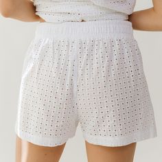 Whether you're lounging by the pool or heading to the beach, these shorts have you covered. A high-waisted fit and an elastic waistband mean ultimate comfort, and a 100% cotton eyelet fabric means breezy, beachy style. Beach coverup Elastic waistband High-waisted shorts Breezy, lightweight fabric Available as a matching set! FREE U.S. Standard Shipping! More info hereModel Hannah is wearing size XS100% COTTONHand wash cold and lay flat or hang to dry Elastic Waistband Shorts For Beach Loungewear, White Summer Pajama Shorts For Vacation, Summer Cotton Shorts For Poolside, Summer Pajama Shorts For Beach Season Loungewear, Summer Pajama Shorts For Beach Loungewear, Cotton Shorts For Poolside, White Cotton Pajama Shorts For Beach Season, Summer Pajama Shorts For Loungewear During Beach Season, Beachwear Shorts With Elastic Waistband For Day Out