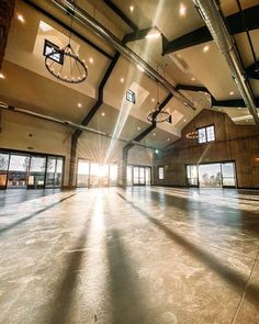 an empty room with lots of windows and lights