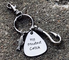 a metal keychain with a fish on it that says, my greatest catch