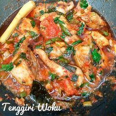 chicken and vegetable stew in a wok with a wooden spoon, ready to be eaten