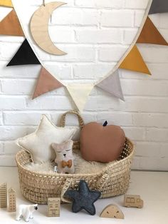 a basket filled with toys sitting on top of a white table next to a brick wall