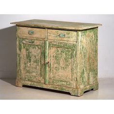 an old green cabinet with two drawers