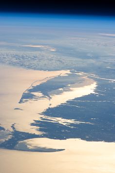 an aerial view of the ocean and land