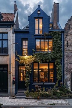 a house with ivy growing on the side of it's windows and front door