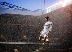 a soccer player jumping in the air to catch a ball during a rain soaked game