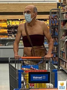 an older man wearing a face mask while pushing a shopping cart in a grocery store