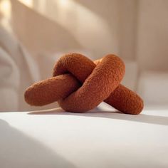 two pieces of bread sitting on top of a bed