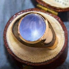 a blue ring sitting on top of a wooden box