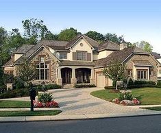 a large house with lots of windows and landscaping