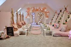 a room filled with lots of pink and white decorations on top of carpeted floors