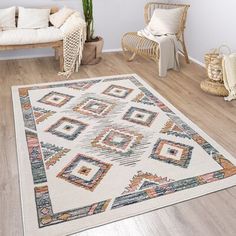 a living room with white walls and wooden flooring, including a large rug on the floor