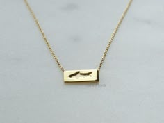 "Gold Dipped Rectangle Bar Shark Imprint Pendant Necklace. Crafted with meticulous attention to detail, this necklace features a unique pendant in the shape of a rectangle bar, adorned with an edgy and striking shark design. The pendant showcases a sleek and modern shark motif, expertly crafted from high-quality alloy and dipped in a layer of luxurious 18k gold. Its clean lines and distinct shape create a captivating piece that exudes confidence and strength. The pendant hangs gracefully from a dainty gold chain, adding an element of sophistication to your ensemble. Wearing this Rectangle Bar Shark Pendant Necklace is a powerful way to express your individuality and showcase your fearless nature. It serves as a reminder to embrace your inner strength and navigate through life's challenges Toddler Earrings, Shark Pendant, Surf Jewelry, Shark Design, Shark Necklace, Shark Earrings, Claw Necklace, Jewelry Bridesmaid, Etsy Bridesmaid Gifts