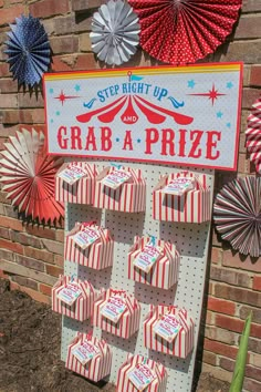 a sign that says grab - a - prize next to some paper fans and pinwheels