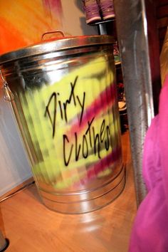 a trash can with the word dirty clothes written on it