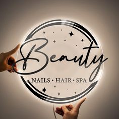 two hands holding a beauty sign with the word nails, hair - spa written on it