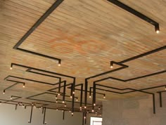 an image of a room that has been decorated with wood planks and lights hanging from the ceiling