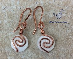 the earrings are made with copper wire and white beads