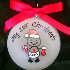 a glass ornament with a cartoon character holding a candy cane in it's hand