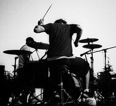 black and white photograph of drummer playing drums