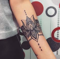 a woman's arm with a tattoo on it and a flower in the middle