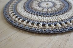 a crocheted coaster sits on a wooden surface