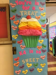 a bulletin board that says you're in for a treat with a cupcake on top