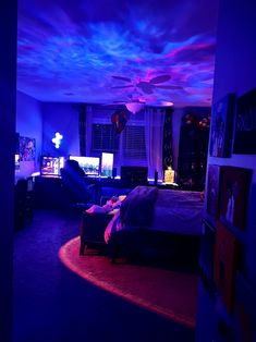 a bedroom with purple and blue lighting in the ceiling