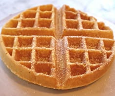 a waffle sitting on top of a white plate