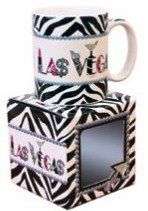 two zebra print coffee mugs stacked on top of each other, one with the word love