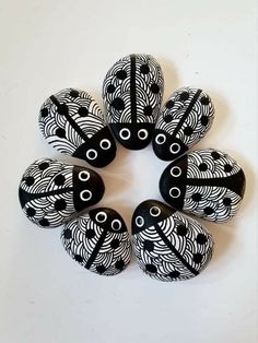 six black and white beads with circles on them