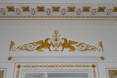 an ornate gold and white design on the ceiling