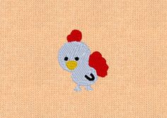 an embroidered image of a chicken with a red comb on it's head and tail