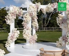 an outdoor wedding setup with white and pink flowers