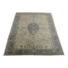 an antique rug with blue and beige colors on the bottom, it is in very good condition