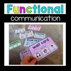 a hand holding a pink and white card with the words functional communication written on it