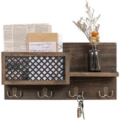 a wooden shelf with hooks and keys on it