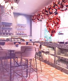 the interior of a restaurant with tables and chairs