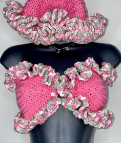 two crocheted hats are on top of a mannequin's head