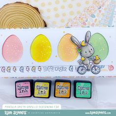 an easter card with three small stamps and a piece of cake in the back ground