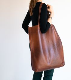 "Very Large Women Bag, Cognac Brown Oversized tote bag, Large weekender Bag, Leather Tote Bag AVAILABLE COLORS: COGNAC BROWN: https://etsy.me/2PUR0uU BLACK: SOON MORE COLORS SOON Very Large Bag made of soft cowhide - natural leather The oversize tall bag has a simple design and practical character that will make it very practical in many situations. Bag without lining with two large pockets. Very practical for carrying on the shoulder. To be worn on the shoulder or in the hand. Spacious interior Large Rectangular Leather Bag, Large Leather Satchel Bag, Large Brown Leather Shoulder Bag, Large Leather Satchel For Shopping, Large Leather Everyday Bags, Large Leather Bags For Everyday Use, Brown Bag With Long Handle For Everyday, Large Leather Tote Satchel, Rectangular Shoulder Bag With Smooth Grain For Errands