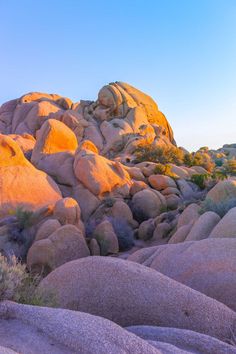 the sun is setting on some rocks in the desert