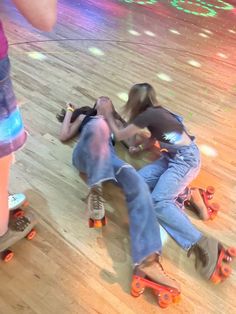 two people laying on the floor with roller skates