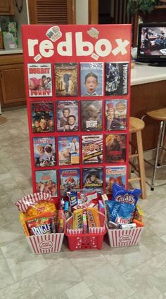 a red poster with movies on it in the middle of a kitchen floor next to two chairs