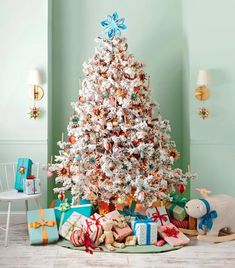 a white christmas tree surrounded by presents