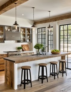 a kitchen with an island and stools in it