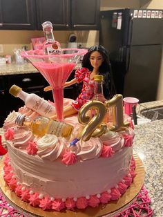 a birthday cake with pink frosting and decorations on it, including a barbie doll