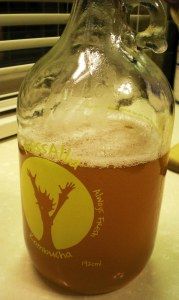 a glass bottle filled with liquid sitting on top of a counter