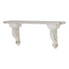 an old white wooden shelf with two brackets